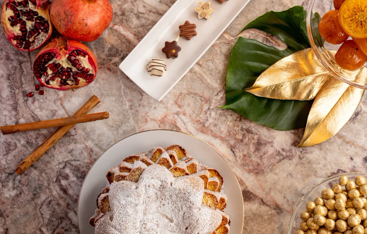 Selection of Christmas desserts with pandoro, cinnamon, pomegranate, chocolate and candied fruit at Hotel Eden, Rome