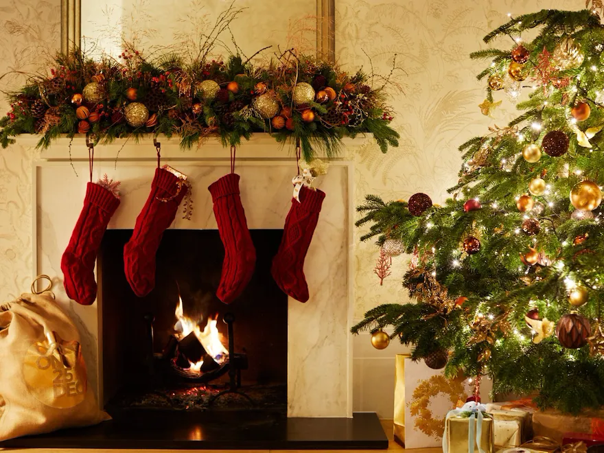 Christmas tree and log fire in suite at coworth park