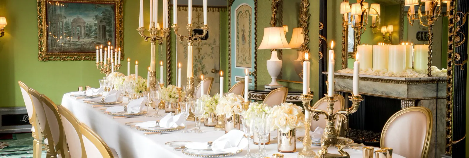 Penthouse and Pavilion event room set up for social dinner with white flowers and candles