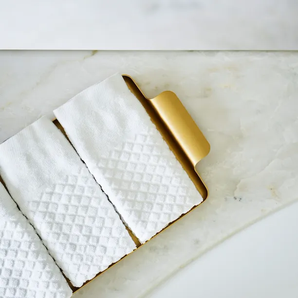 White towels on marble surface inside bathroom of Bellavista penthouse suite at Hotel Eden, Rome