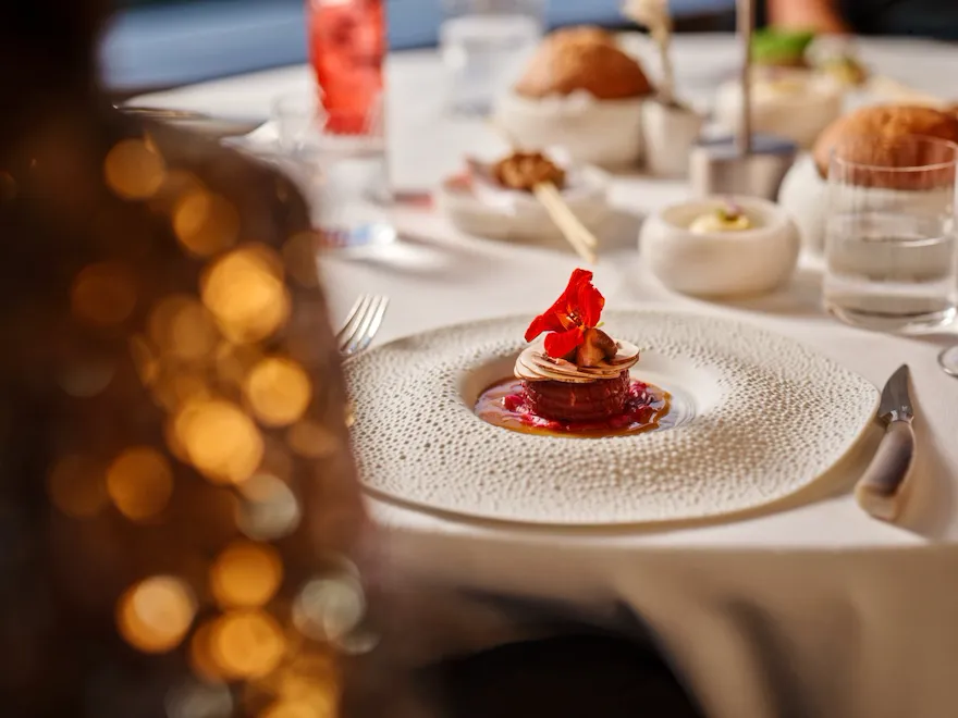 Elegant dining table with a beautifully plated dish and soft ambient lighting