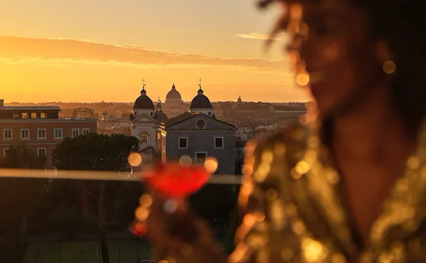 Girl having a drink and city view on background