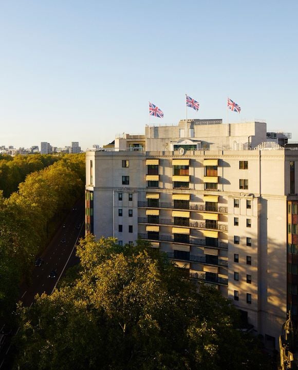 The Dorchester building exterior at sunset next to Hyde Park, London