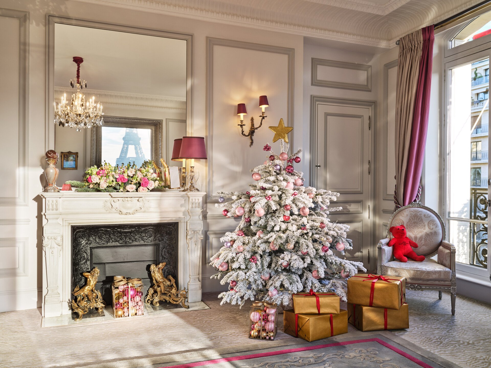 Picture of a room with white christmas tree and gifts.