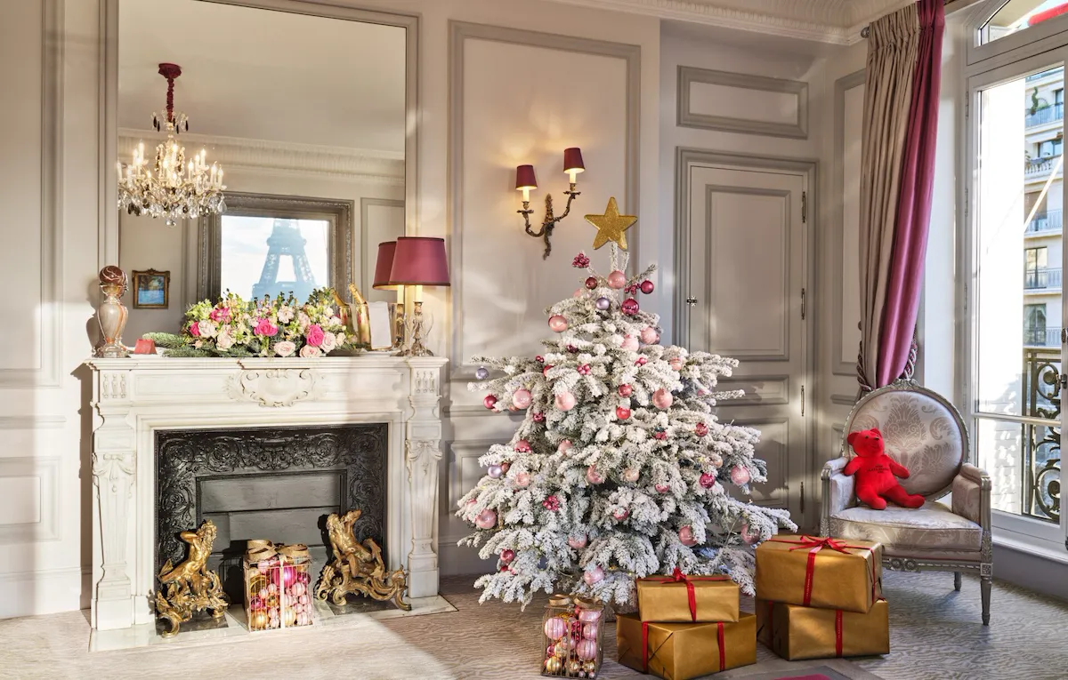 Picture of a room with white christmas tree and gifts.