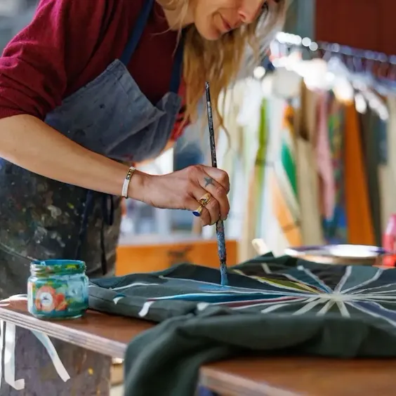 Zazie painting a jacket in her atelier in Trastevere, Rome