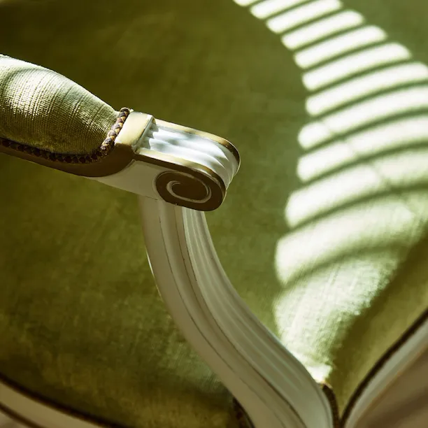 Chair with green fabric in the Parisienne suite, at Le Meurice, Paris.