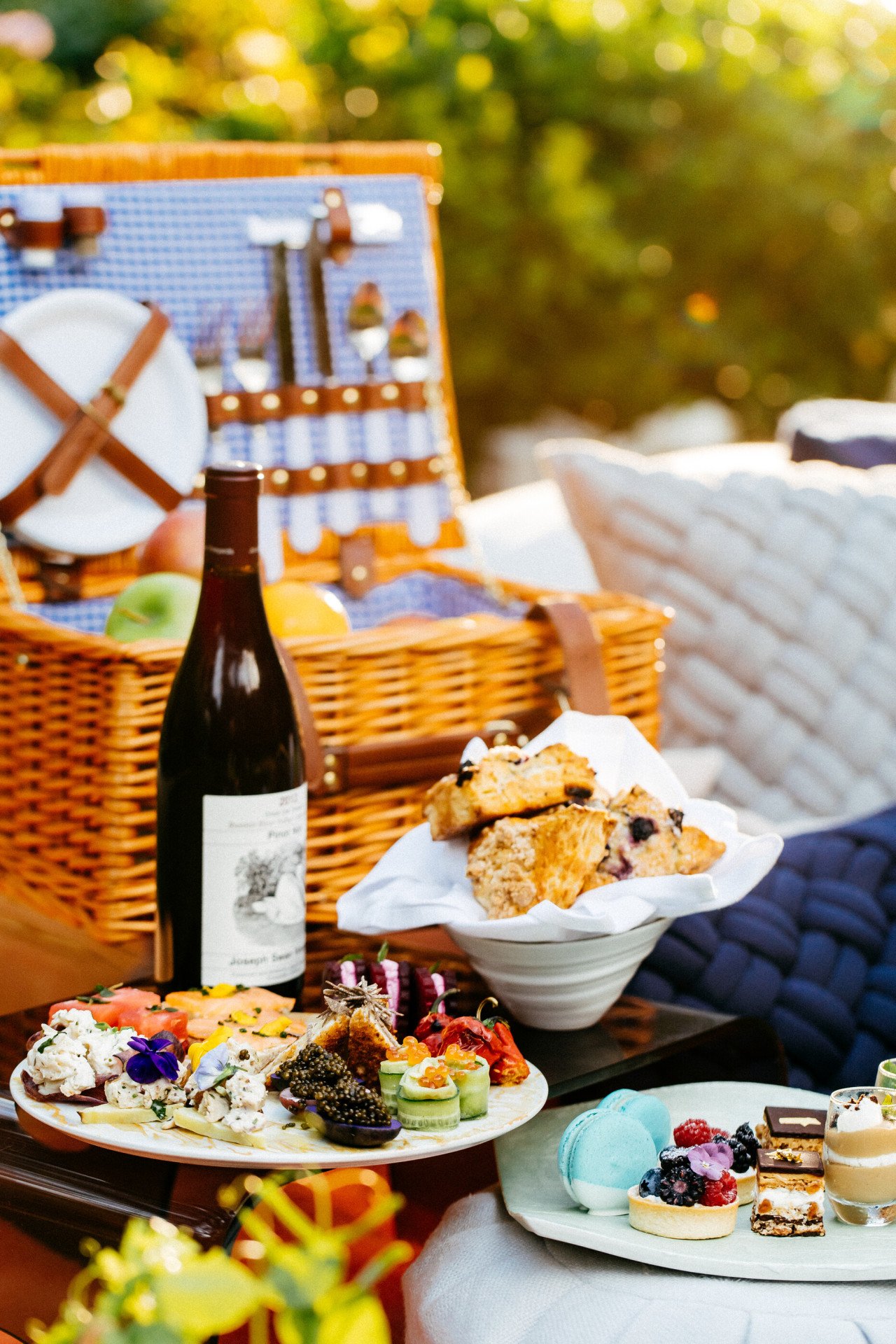 Picnic al fresco on blanket by swan lake at Hotel Bel-Air