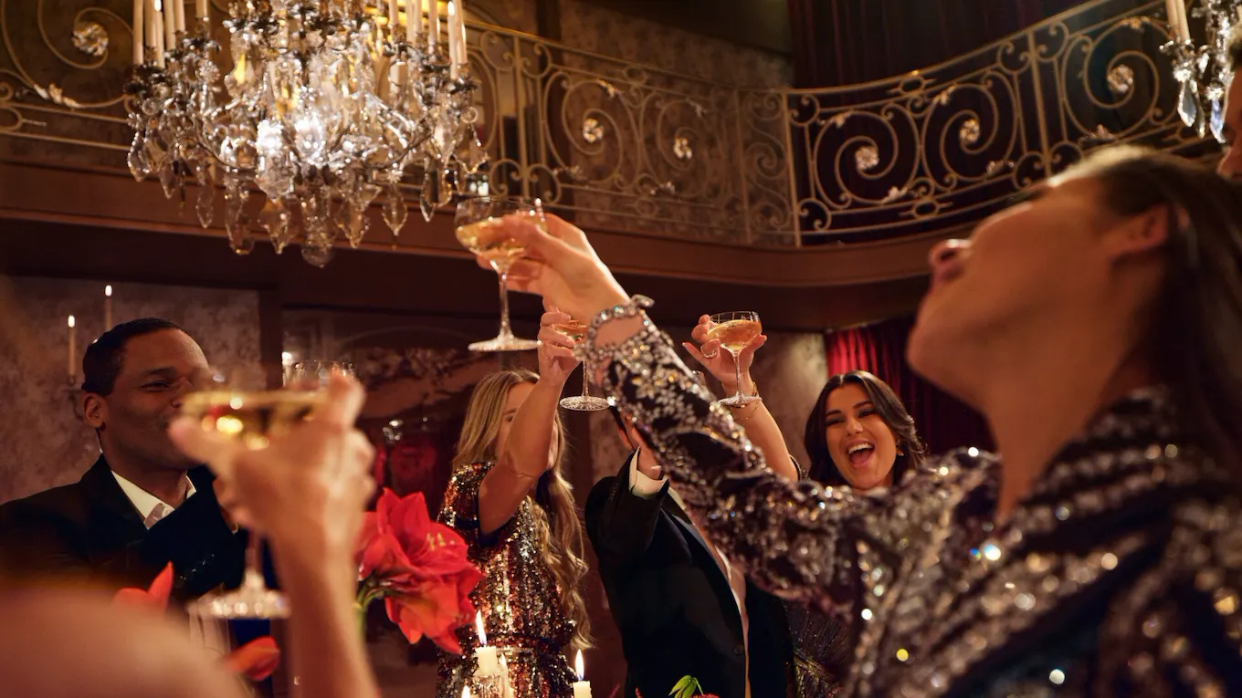 People say cheers in Le Salon Haute Couture, at Hôtel Plaza Athénée, Paris - Dorchester Collection.