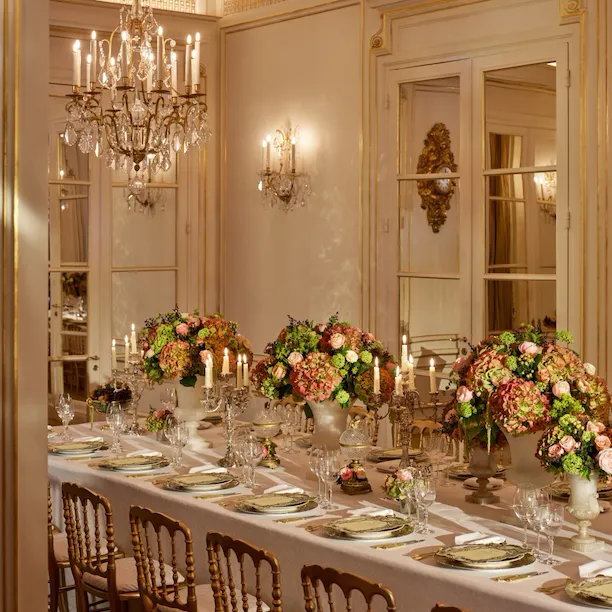 Dinner captured with gold and white tableware, pink and green flowers, green cakes, at Le Salon Organza, at Hôtel Plaza Athénée, Paris - Dorchester Collection.