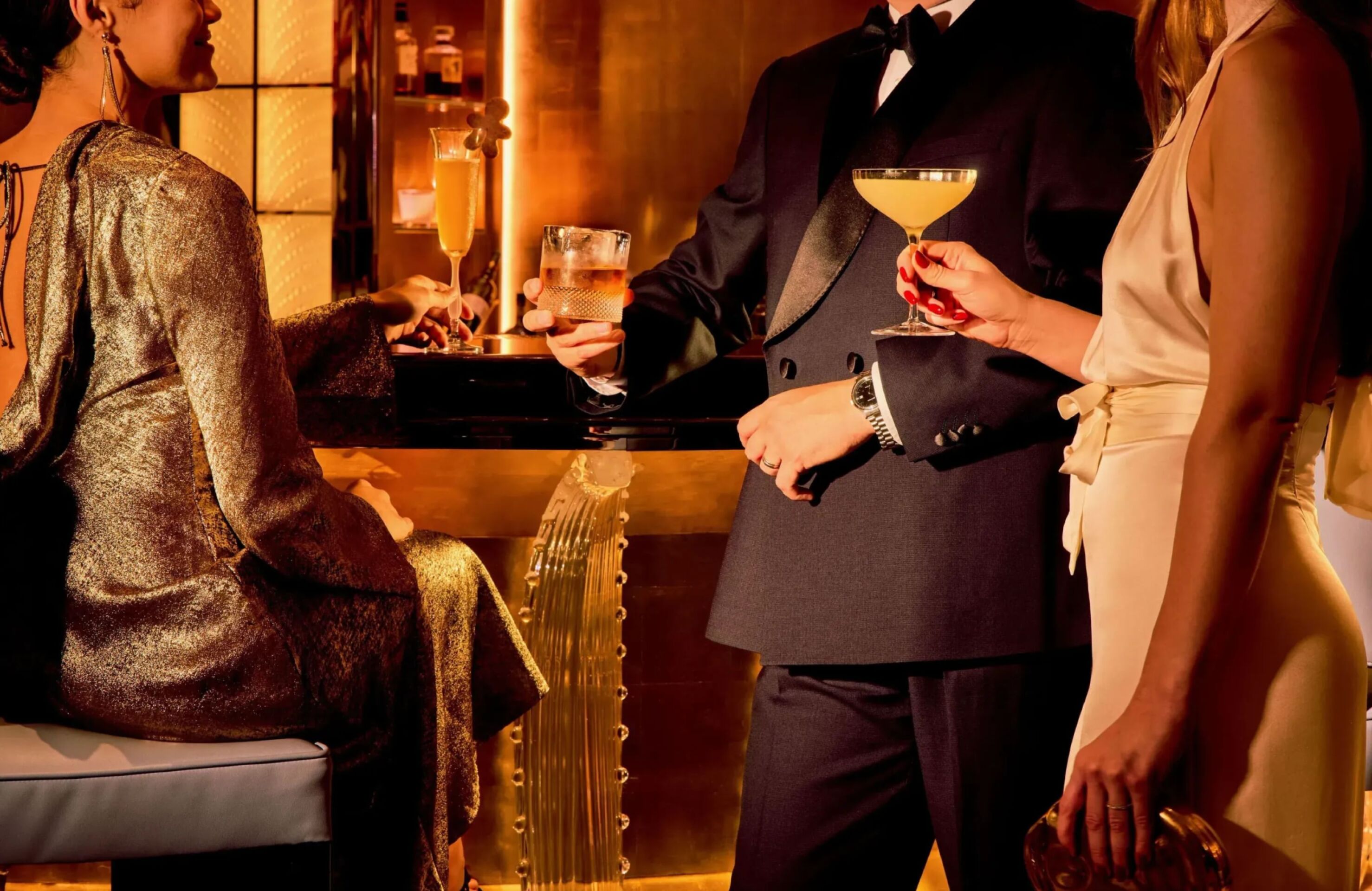 Pre-dinner drinks at the Artists' Bar with three models in warm lighting