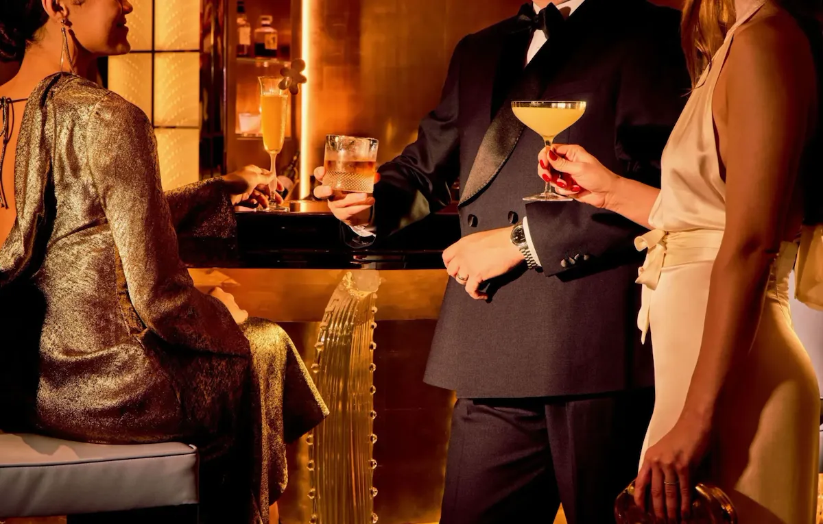 Pre-dinner drinks at the Artists' Bar with three models in warm lighting