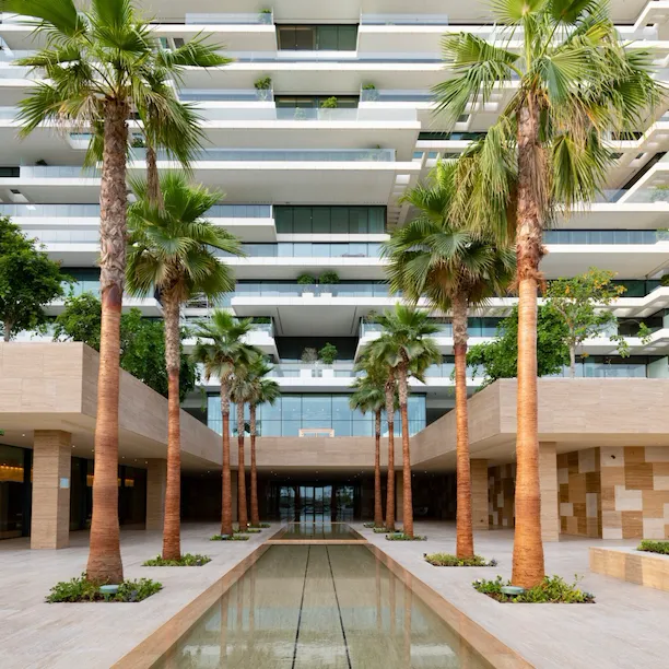 Palm tree-lined water feature in front of One at Palm Jumeirah, Dubai