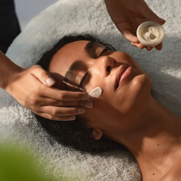 The Dorchester Spa Treatment Facial Cream being applied to woman's face