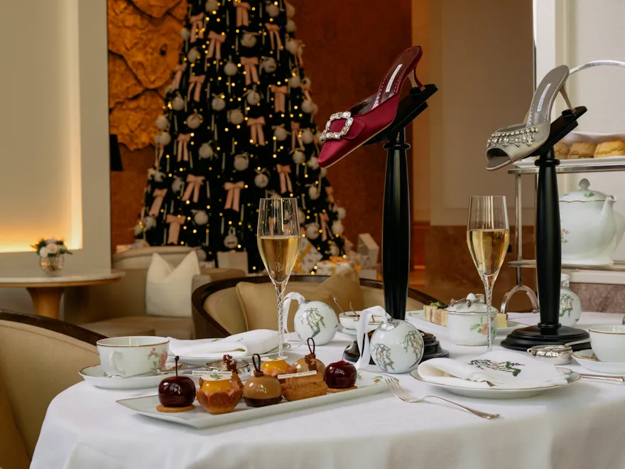 A close up of The Gallery's afternoon tea with the Christmas tree in the back