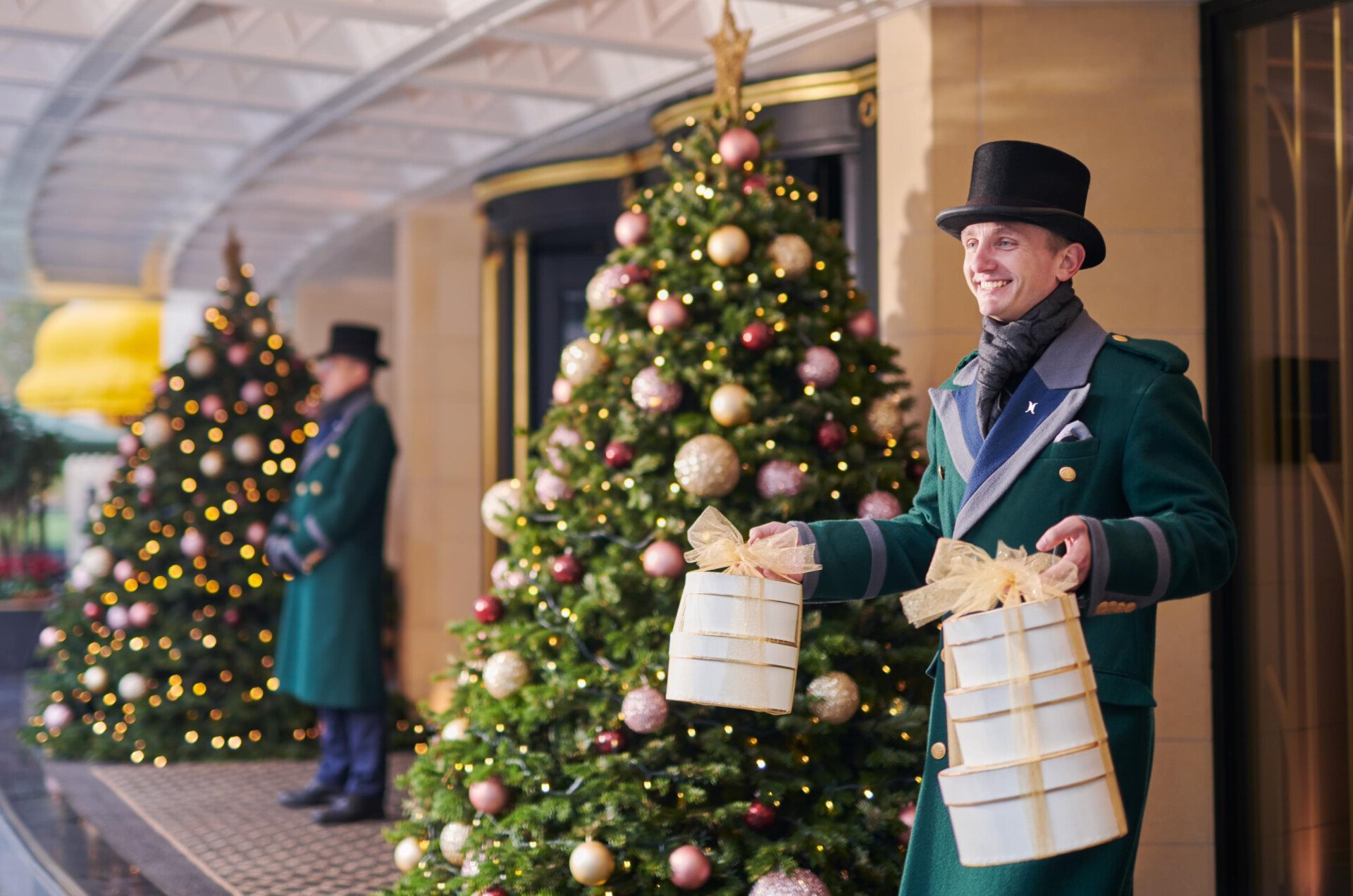 The Dorchester Doorman carrying a Christmas Present outside of The Dorchester