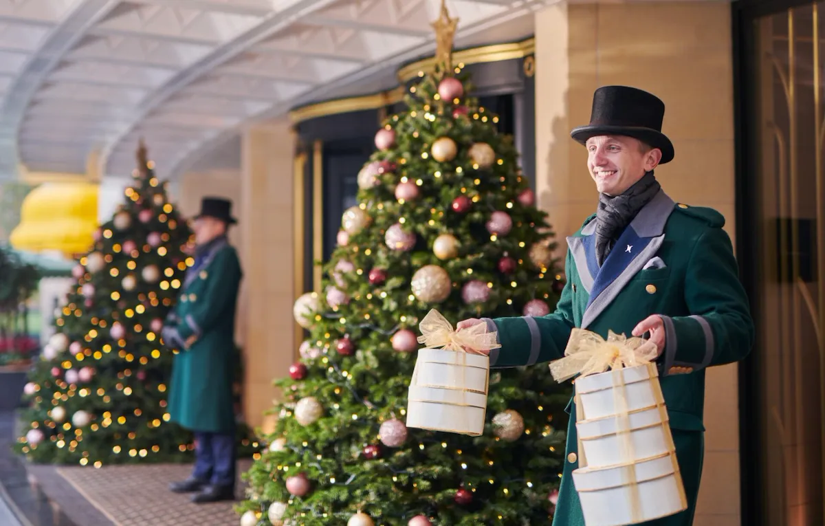 The Dorchester Doorman carrying a Christmas Present outside of The Dorchester