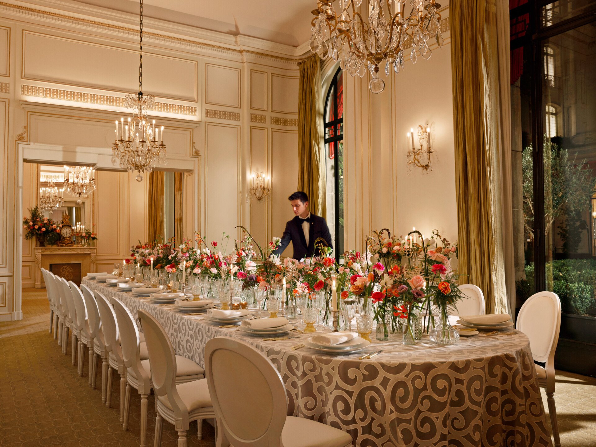 Table captured with colorful flower arrangement at Le Salon Organza, Hôtel Plaza Athénée, Paris - Dorchester Collection.