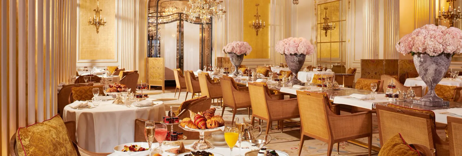 Images of the brunch at the Jean Imbert au Plaza Athénée. There is a whole chicken, some salads, eggs and pastries displayed on the table as well as juices and champagne