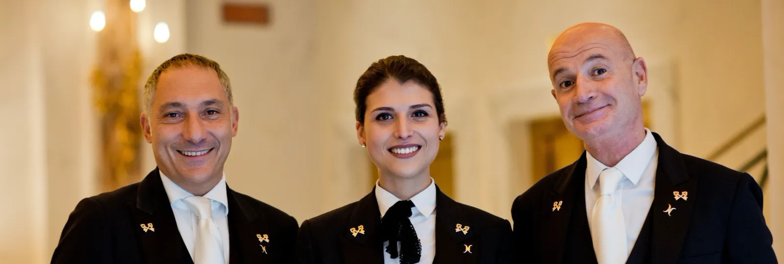 Portrait of smiling concierge team at Hotel Eden, Rome