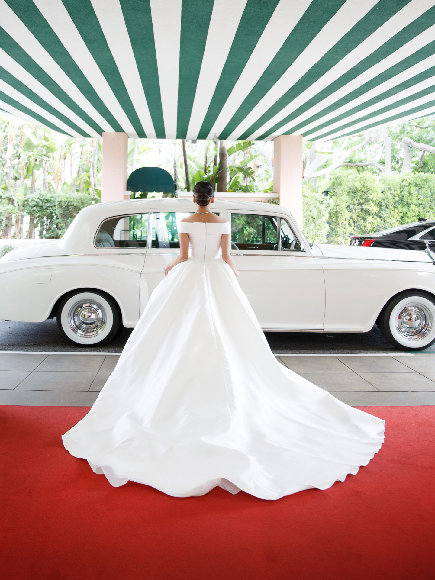 a bride standing in front of beverly hills hotel