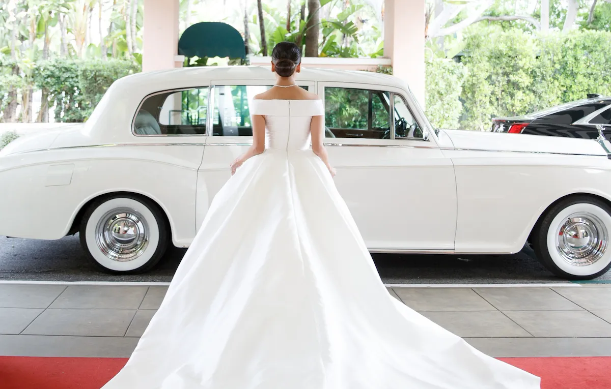 a bride standing in front of beverly hills hotel