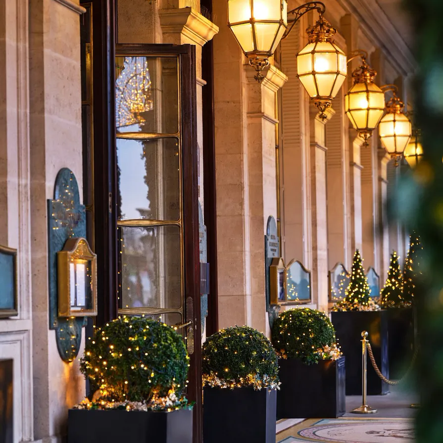 View under the arcades on lamps and Christmas trees along the hotel, at Le Meurice, Paris