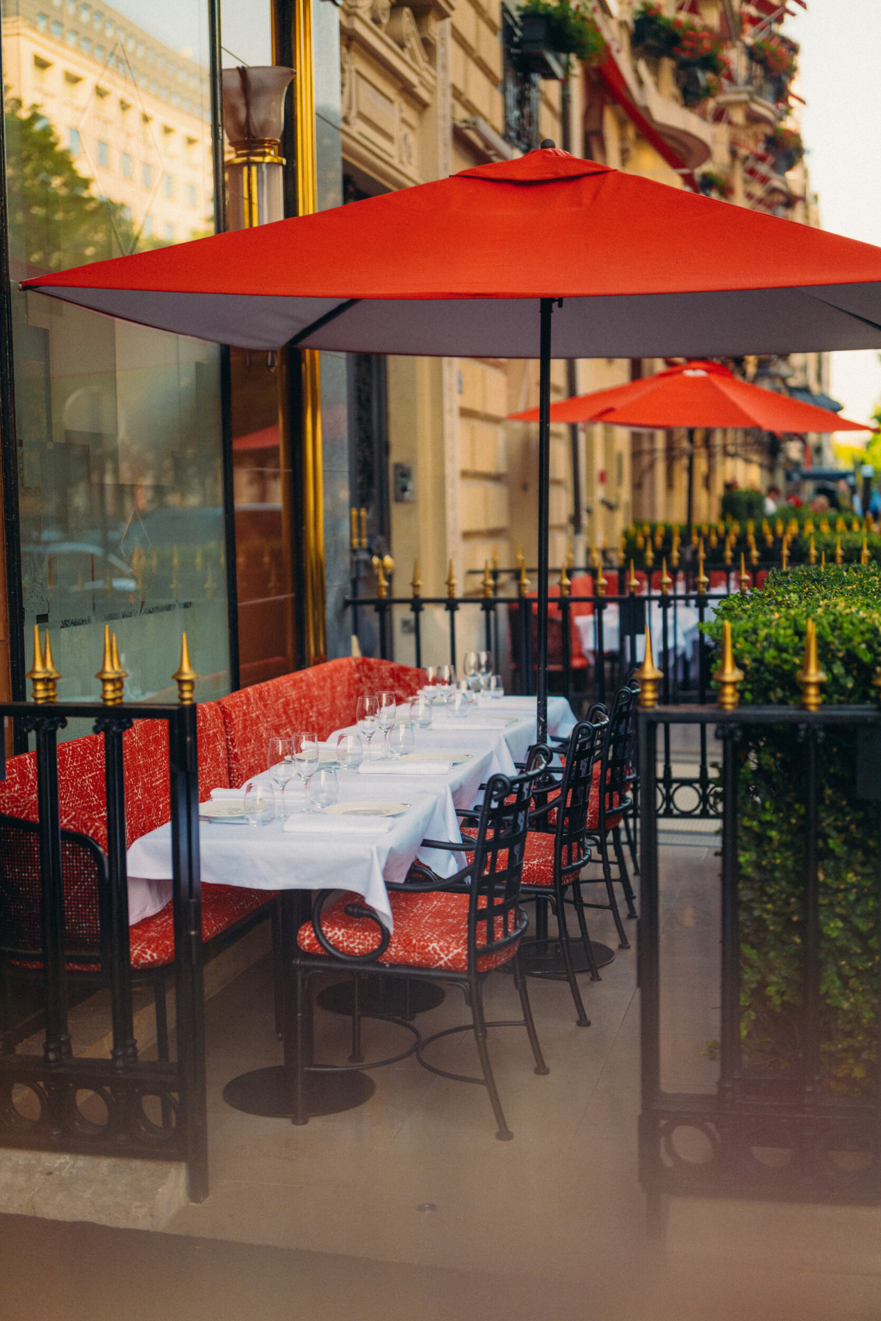Relais Plaza's terrace with drawned up dining tables and Plaza's facade in the background, at Hotel Plaza Athénée, Paris