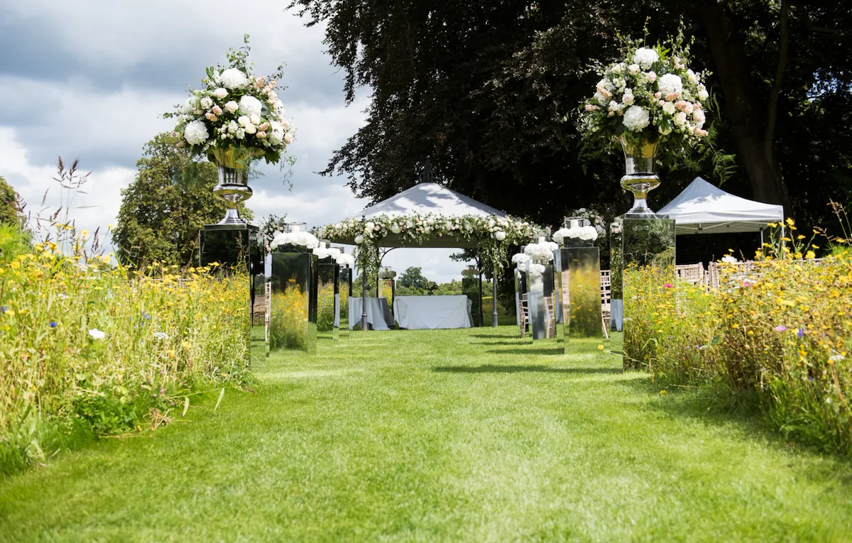 Coworth Park-Weddings-Meadow aisle-Credit Fiona Kelly