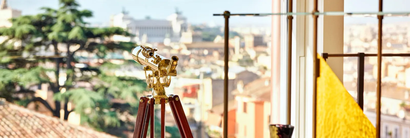 Telescope in front of open window in Bella Vista Penthouse suite at Hotel Eden, Rome