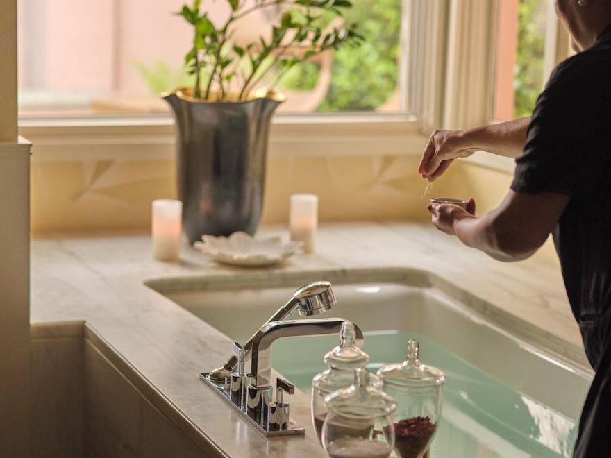 therapist prepping bathtub in couples treatment room 