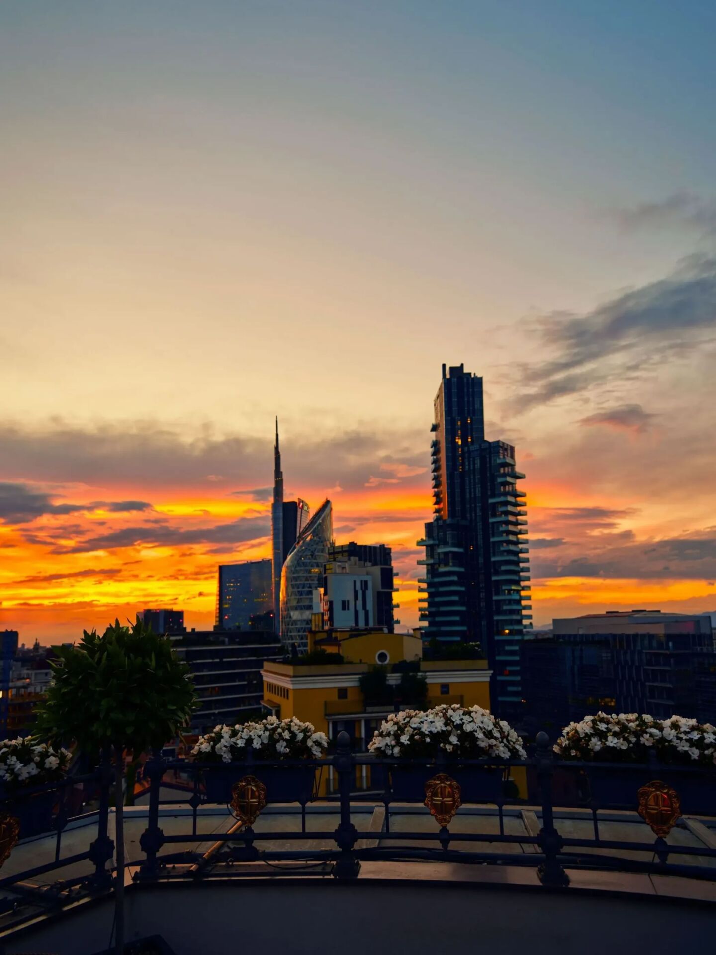 view from Hotel Principe di Savoia rooftop on Porta Nuova district with sunset