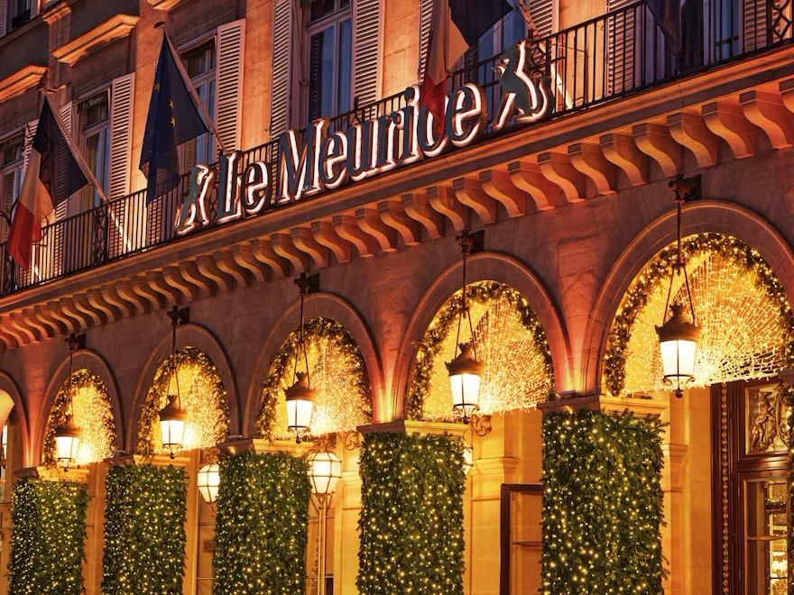 Zoom on the hotel by night, with Christmas trees on the arcades and the lights that illuminate the hotel, at Le Meurice, Paris