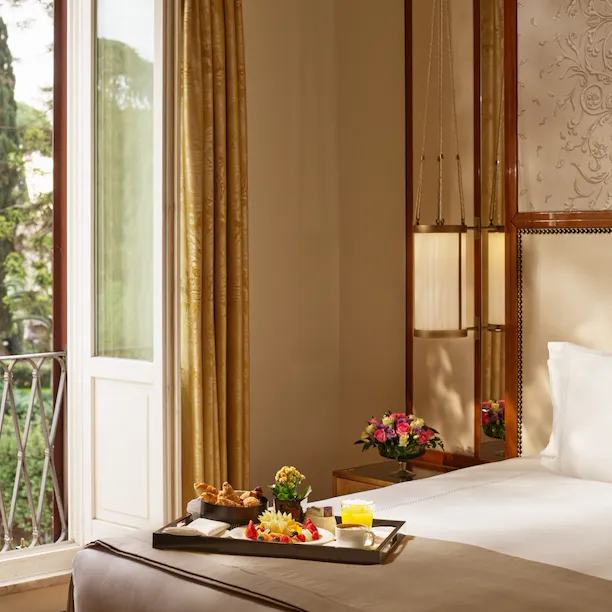 Bedroom of classic room with view, breakfast tray on the bed, at Hotel Eden