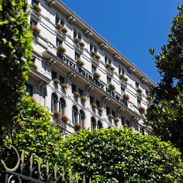 Exterior of Hotel Principe Di Savoia from ground level on a sunny day, Milan