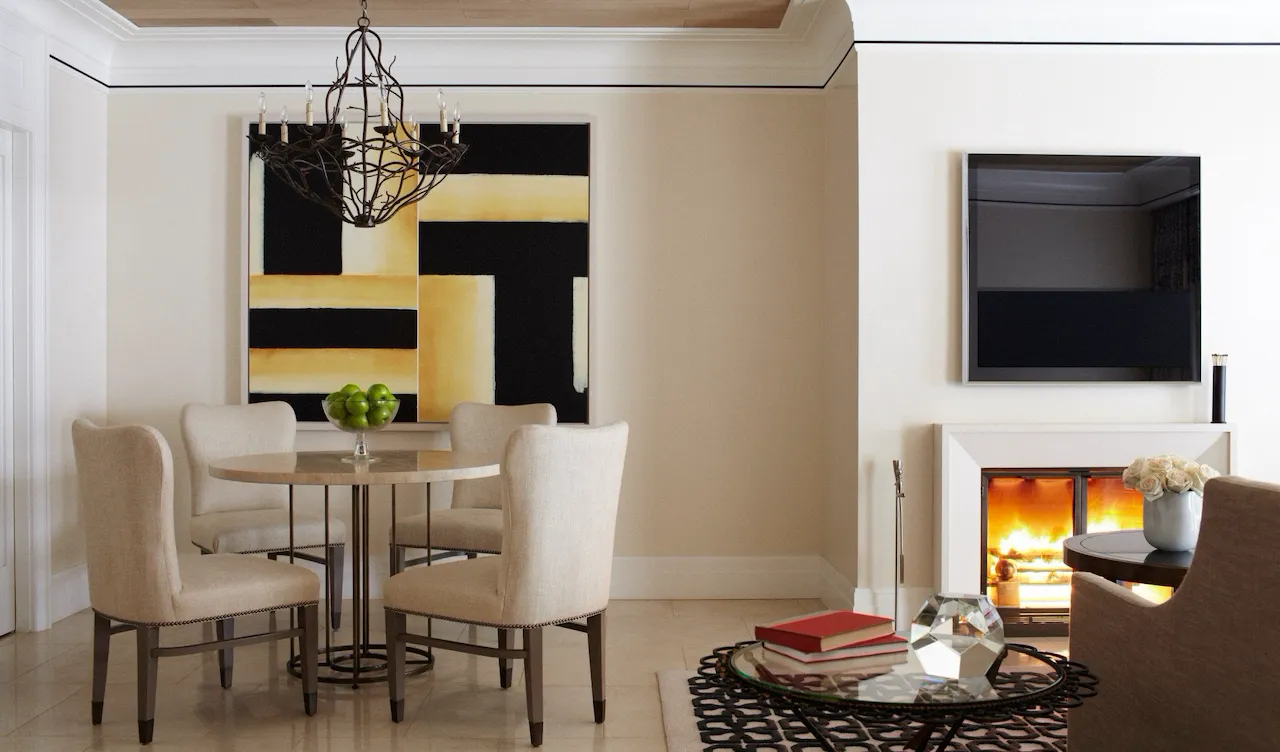 Dining table for four in the Stone Canyon suite with fireplace