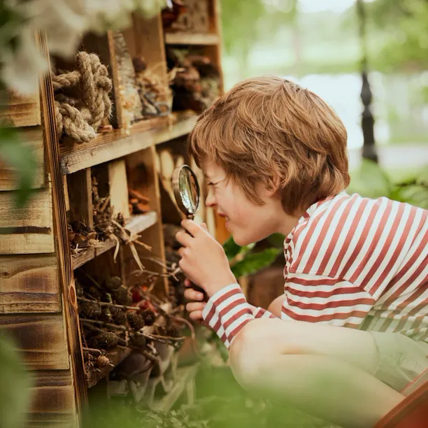 Children playing with flowers and wild flowers in the Coworth Park Grounds
