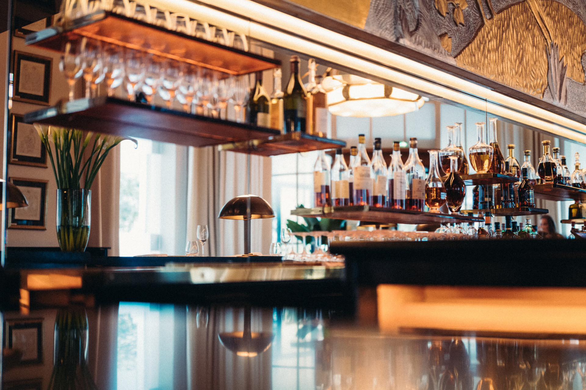 Le Relais Plaza bar wiith alcohol bottles and glasses, at Le Relais Plaza, at Hotel Plaza Athénée, Paris