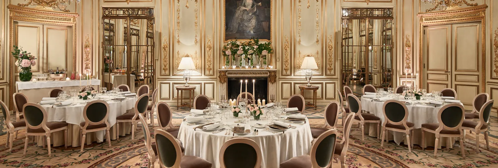 Photo of Salon Pompadour bright Versailles-style event room, set for dinner with three round and large dressed tables at Le Meurice, Paris