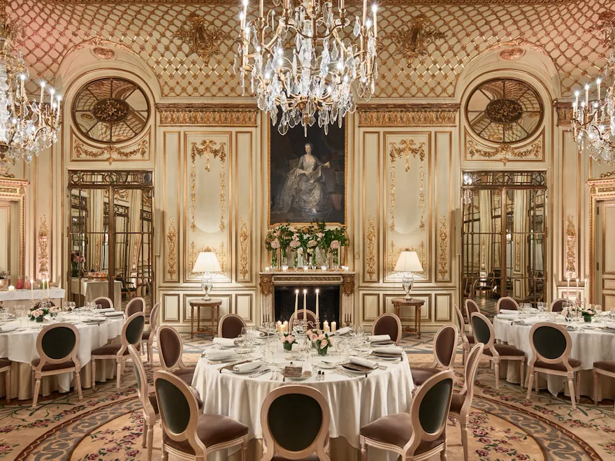 Photo of Salon Pompadour bright Versailles-style event room, set for dinner with three round and large dressed tables at Le Meurice, Paris