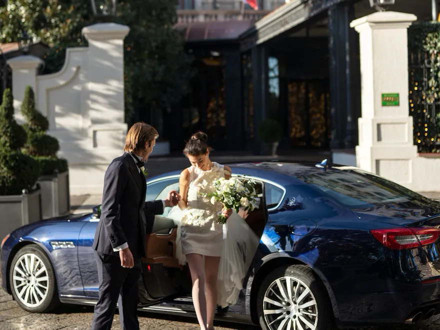 Couple outside in front the facade entering the hotel