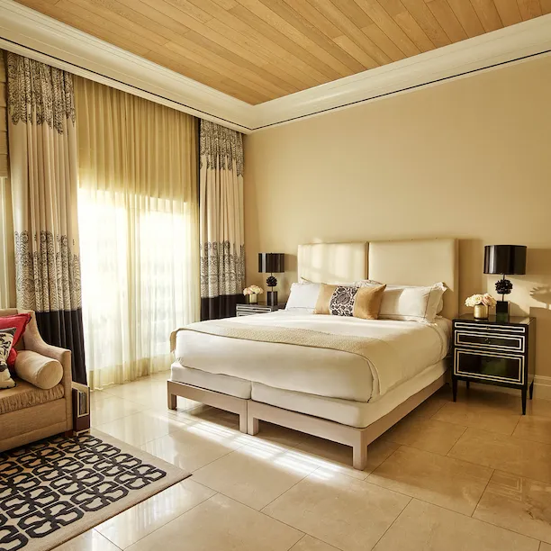 Deluxe guestroom with patio and ray of light coming in