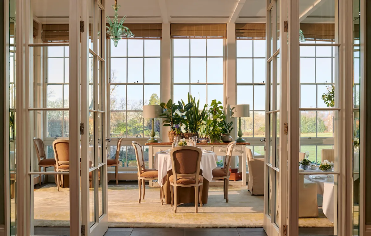 Open glass doors leading to a set up table in the central portion of the image.