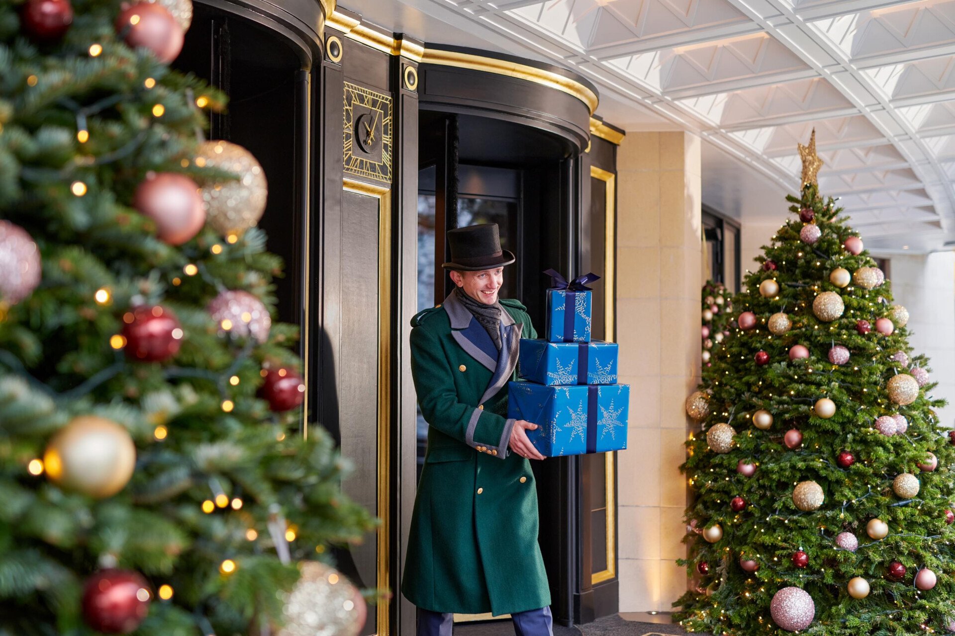 The Dorchester Doorman carrying a Christmas Present