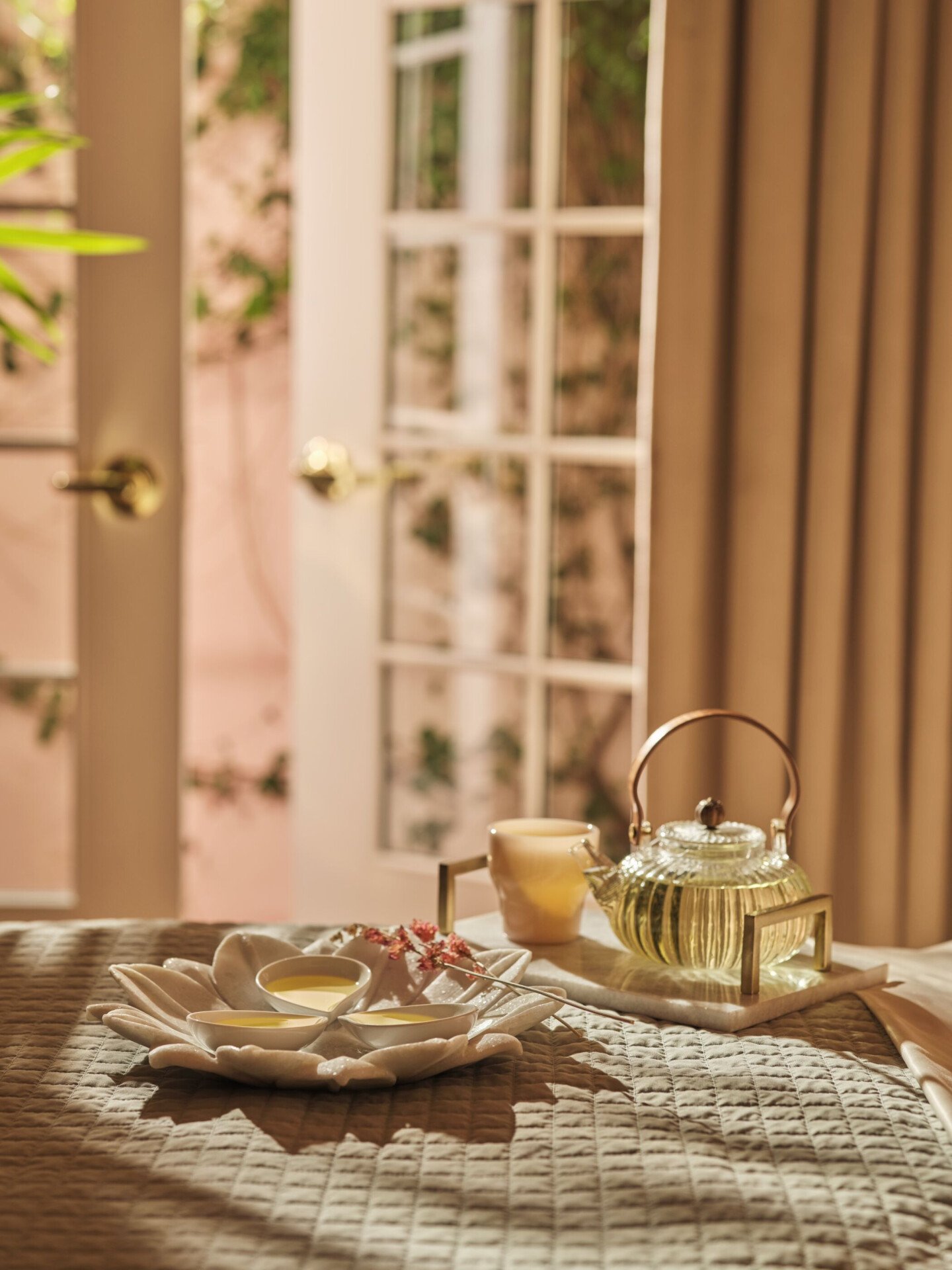 treatment oils on bed with tea set-up moment 