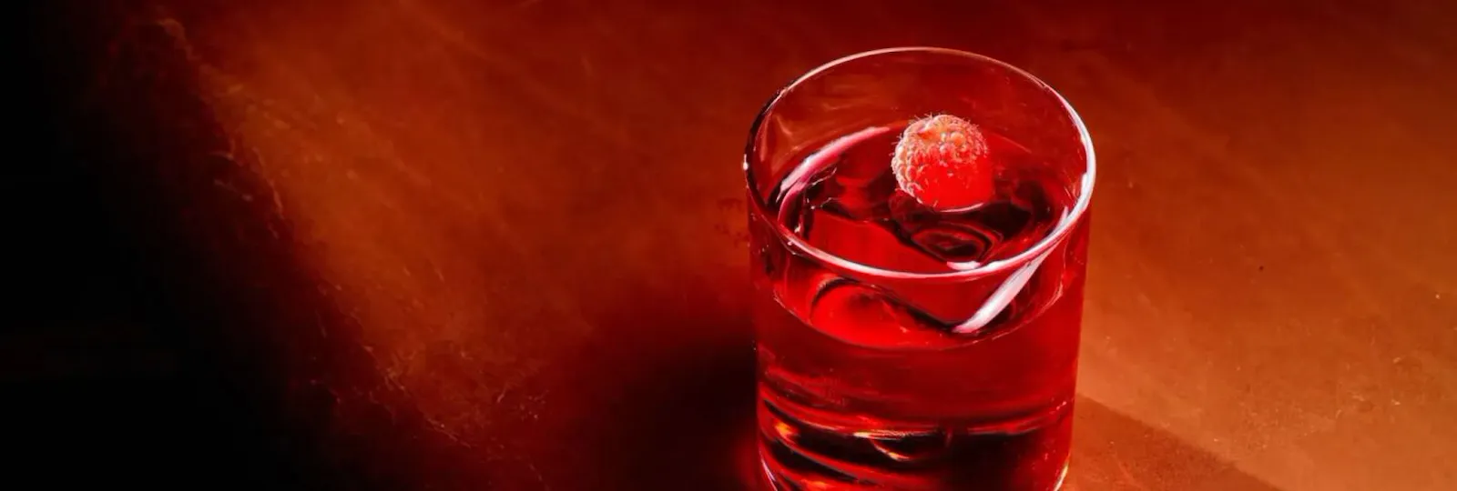 Negroni cocktail served in a cut-crystal tumbler with ice and garnish at The Grill at The Dorchester.