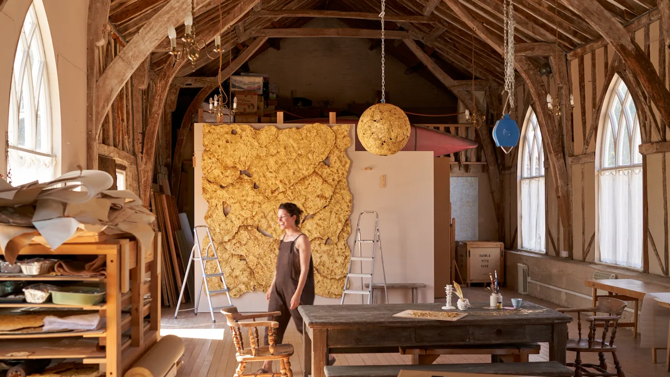 Sophie Coryndon artist in her studio in front of 'The Dorchester Dossel' artwork