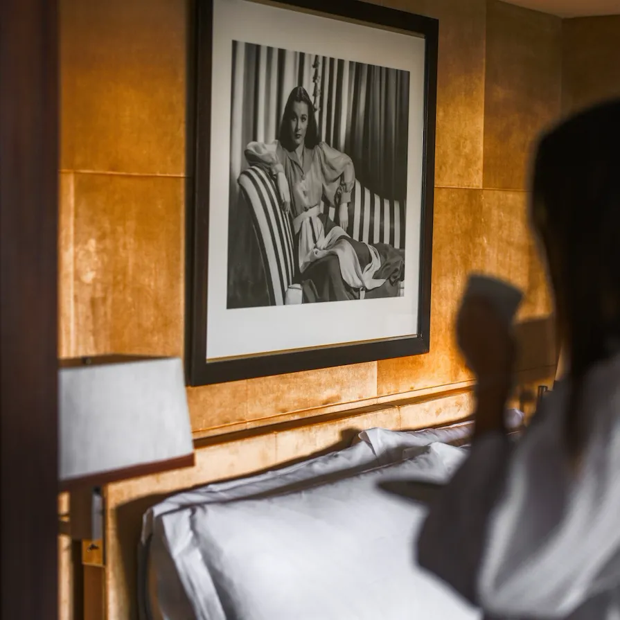 Lady drinking tea in bedroom