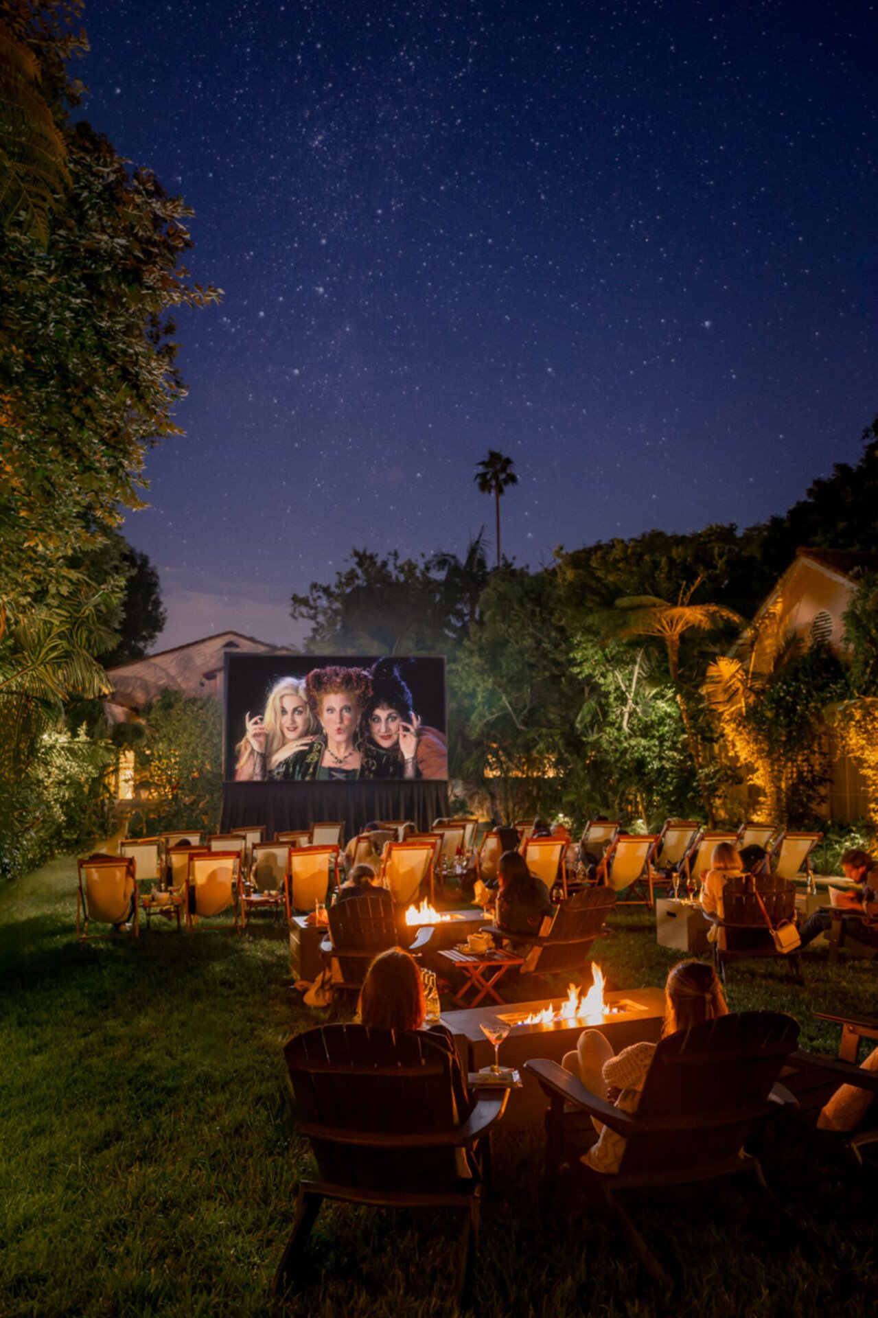 Outdoor movies series on the front lawn, guests watching Halloween movie 