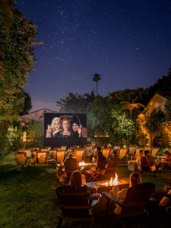 Outdoor movies series on the front lawn, guests watching Halloween movie
